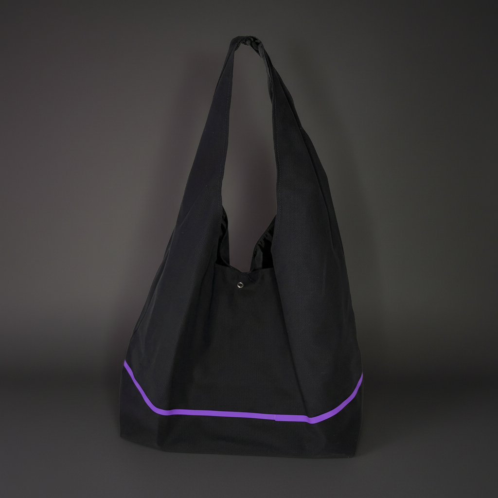 Black tote bag with purple trim on a dark gray background