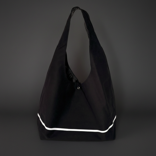 Black bag with white trim on a dark gray background